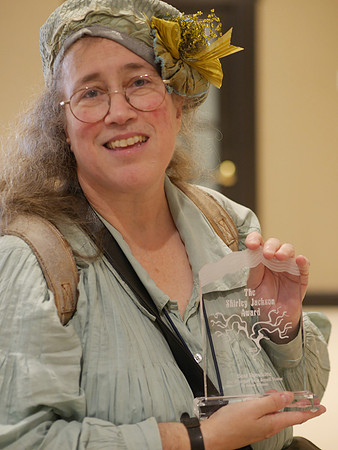 Greer Gilman and her Shirley Jackson Award plaque